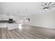 Bright, open-concept living space with wood floors, modern lighting, and neutral decor at 11598 Oak Ln, Largo, FL 33778