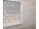 Detailed view of the shower niche with appealing grey and white honeycomb tile pattern and light stone shelf at 11598 Oak Ln, Largo, FL 33778
