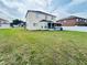 A spacious backyard featuring a vinyl fence and screened in porch at 12814 Longcrest Dr, Riverview, FL 33579