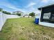 A spacious backyard features a vinyl fence, some grass, and a screened-in porch at 12814 Longcrest Dr, Riverview, FL 33579