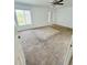 Bedroom with carpeted floor, ceiling fan and a view of the yard from windows at 12814 Longcrest Dr, Riverview, FL 33579
