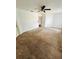 Bedroom with carpeted floor, ceiling fan and natural light with several door entrances at 12814 Longcrest Dr, Riverview, FL 33579