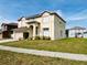 View of two-story home showcasing manicured lawn and tidy landscaping at 12814 Longcrest Dr, Riverview, FL 33579