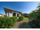 Backyard view features lush landscaping and the exterior of the home at 13917 Kingfisher Glen Dr, Lithia, FL 33547