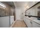Bright bathroom boasts double vanity with granite counters and tiled walk-in shower at 13917 Kingfisher Glen Dr, Lithia, FL 33547