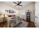 Comfortable bedroom with ceiling fan, wooden floors and a sunny window at 13917 Kingfisher Glen Dr, Lithia, FL 33547