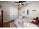 Cozy bedroom with ceiling fan, floral quilt, and double door closet provides a serene retreat at 13917 Kingfisher Glen Dr, Lithia, FL 33547