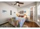 Comfortable bedroom with ceiling fan, wooden floors and a sunny window at 13917 Kingfisher Glen Dr, Lithia, FL 33547