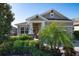 Inviting front porch with seating area, a brick floor, and decorative plants enhancing the home's curb appeal at 13917 Kingfisher Glen Dr, Lithia, FL 33547