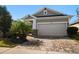 Single-story home features a two-car garage and brick-paved driveway complemented by manicured landscaping at 13917 Kingfisher Glen Dr, Lithia, FL 33547