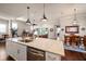 Open concept kitchen with island seating, stainless steel appliances, and easy access to the living and dining areas at 13917 Kingfisher Glen Dr, Lithia, FL 33547
