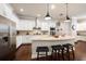 A view of the kitchen showcasing white cabinetry, granite countertops, and stainless steel appliances at 13917 Kingfisher Glen Dr, Lithia, FL 33547