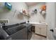 Functional laundry room with modern washer and dryer, storage shelves, and a utility sink at 13917 Kingfisher Glen Dr, Lithia, FL 33547
