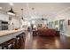 Spacious living room with open views to the kitchen and dining area for seamless entertaining at 13917 Kingfisher Glen Dr, Lithia, FL 33547