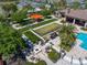 Aerial view of outdoor lounge area with seating, fire pit, and barbecue space near the pool at 13917 Kingfisher Glen Dr, Lithia, FL 33547
