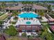 Aerial view of community pool and outdoor lounge area surrounded by palm trees at 13917 Kingfisher Glen Dr, Lithia, FL 33547