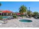 Community spa with lounge chairs and umbrella-covered tables near the pool at 13917 Kingfisher Glen Dr, Lithia, FL 33547