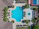 Aerial view of a large swimming pool with ample lounge seating and tropical landscaping in a beautiful community at 13917 Kingfisher Glen Dr, Lithia, FL 33547