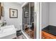 Modern bathroom featuring glass shower, black tile floors, vanity, and stylish decor at 145 19Th Se Ave, St Petersburg, FL 33705