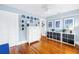 Bedroom featuring hardwood floors, white trim, light blue walls, and built-in shelving at 145 19Th Se Ave, St Petersburg, FL 33705