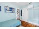 Bright bedroom featuring wood floors, light blue walls, and framed artwork of a seaside scene at 145 19Th Se Ave, St Petersburg, FL 33705
