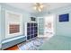 Light blue bedroom with ceiling fan, bench, storage, and view into connected room through french doors at 145 19Th Se Ave, St Petersburg, FL 33705