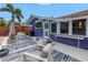 Exterior of a blue house with a charming outdoor lounge area, featuring an outdoor TV at 145 19Th Se Ave, St Petersburg, FL 33705