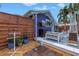 Exterior of blue painted home with patio, outdoor shower, fireplace, and tropical landscaping at 145 19Th Se Ave, St Petersburg, FL 33705
