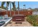 Relaxing backyard featuring a private hot tub, brick patio, tropical plants, and a privacy fence at 145 19Th Se Ave, St Petersburg, FL 33705