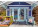 Exterior view of pool house with blue trim and a clear view of the refreshing pool and outdoor furniture at 145 19Th Se Ave, St Petersburg, FL 33705
