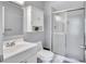 Neutral bathroom with a shower and a cabinet over the sink at 1496 Queen Anne Dr, Palm Harbor, FL 34684