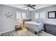 Charming bedroom featuring gray walls, wood-look floors, and natural light at 1496 Queen Anne Dr, Palm Harbor, FL 34684