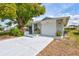 Charming home with a well-maintained front yard and a spacious driveway, offering a welcoming and tidy curb appeal at 1496 Queen Anne Dr, Palm Harbor, FL 34684