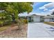 Charming single-story home with a well-maintained lawn and a freshly painted driveway at 1496 Queen Anne Dr, Palm Harbor, FL 34684