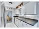 Well-lit kitchen showcasing a stainless steel sink, modern cabinets, and a stylish backsplash at 1496 Queen Anne Dr, Palm Harbor, FL 34684
