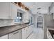Functional kitchen featuring stainless steel appliances, ample counter space and white cabinets at 1496 Queen Anne Dr, Palm Harbor, FL 34684