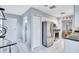 Kitchen view featuring stainless steel appliances, white cabinets, and tile flooring at 1496 Queen Anne Dr, Palm Harbor, FL 34684