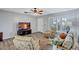 Cozy living room featuring wood floors, comfortable seating, and natural light at 1496 Queen Anne Dr, Palm Harbor, FL 34684
