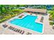 Inviting pool area with ample lounge chairs and shaded seating, perfect for relaxation and socializing at 1496 Queen Anne Dr, Palm Harbor, FL 34684