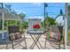 Charming outdoor seating area with a small table, perfect for morning coffee or evening conversations at 1726 25Th S Ave, St Petersburg, FL 33712