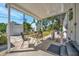 Cozy covered patio with table and chairs, ideal for relaxing and enjoying the outdoors at 1726 25Th S Ave, St Petersburg, FL 33712