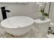 Close-up of bathroom sink with water running into it and a decorative plant on the toilet at 1726 25Th S Ave, St Petersburg, FL 33712
