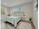 Cozy bedroom with natural light, wood-style flooring, and simple decor at 1726 25Th S Ave, St Petersburg, FL 33712
