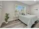 This bedroom has nice, light-colored walls, wood-look flooring, and natural light from the window at 1726 25Th S Ave, St Petersburg, FL 33712