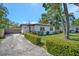 Charming single-story home featuring a well-maintained lawn, mature trees, and a concrete driveway at 1726 25Th S Ave, St Petersburg, FL 33712