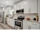 Modern kitchen with white cabinets, granite countertops, and stainless steel appliances at 1726 25Th S Ave, St Petersburg, FL 33712