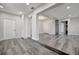 An open living area featuring a staircase, recessed lighting, gray floors, and white doors at 1726 25Th S Ave, St Petersburg, FL 33712