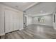 Spacious living room with wood-look flooring, a window, and white closet doors on the left at 1726 25Th S Ave, St Petersburg, FL 33712