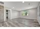 Open living room boasts gray flooring, a brick accent wall, recessed lighting, and a large window at 1726 25Th S Ave, St Petersburg, FL 33712