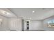 Spacious living room featuring gray wood flooring, recessed lighting, and access to the hallway at 1726 25Th S Ave, St Petersburg, FL 33712